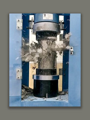Breaking a concrete test cylinder